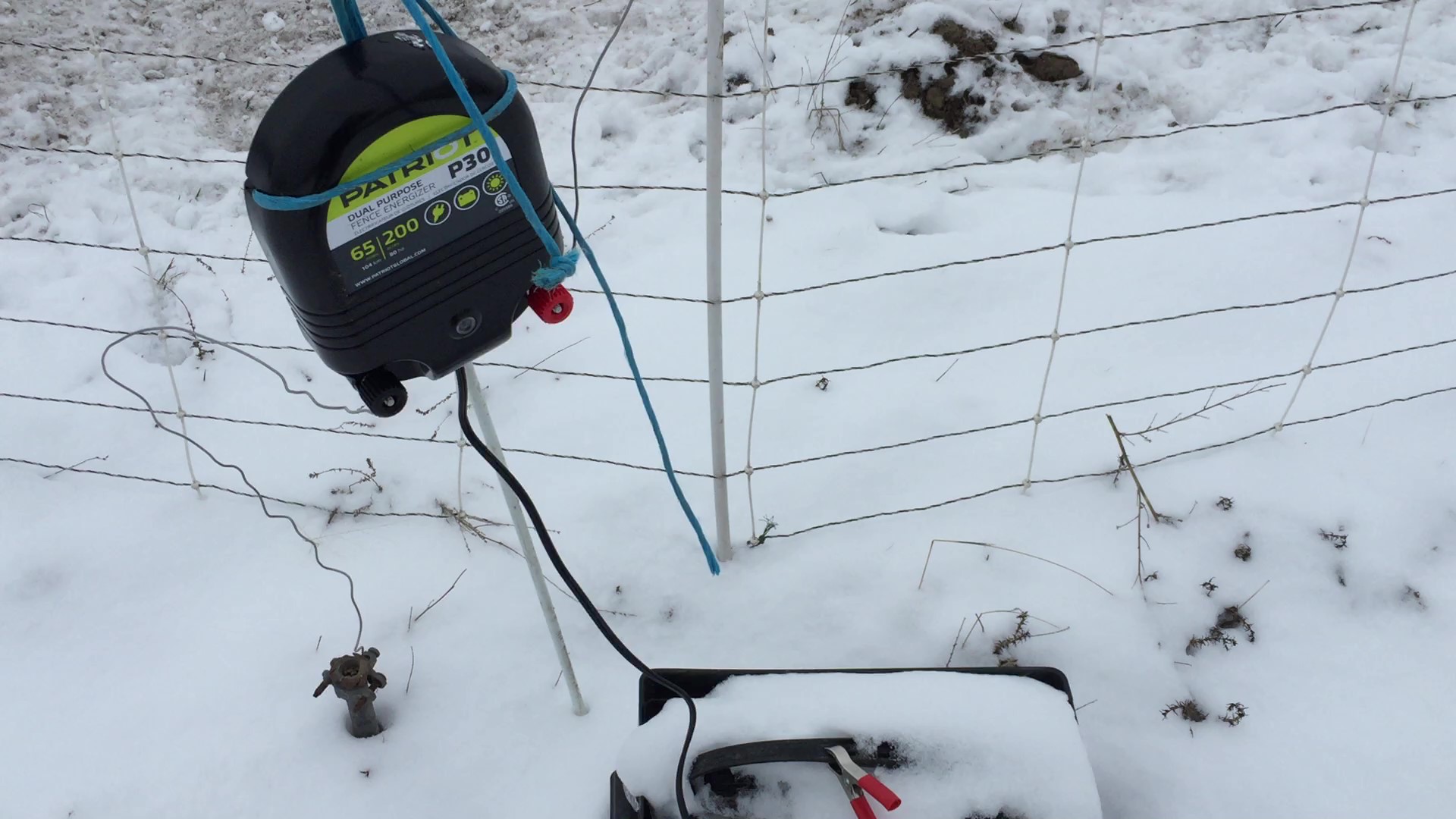 Fence charger and battery in snow
